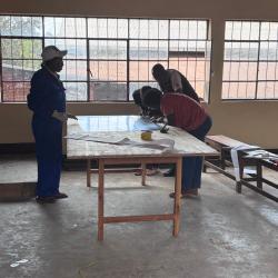 V2SDF training advances to the meticulous process of preparing the mirror substrate for the SK-23 parabolic cooker.