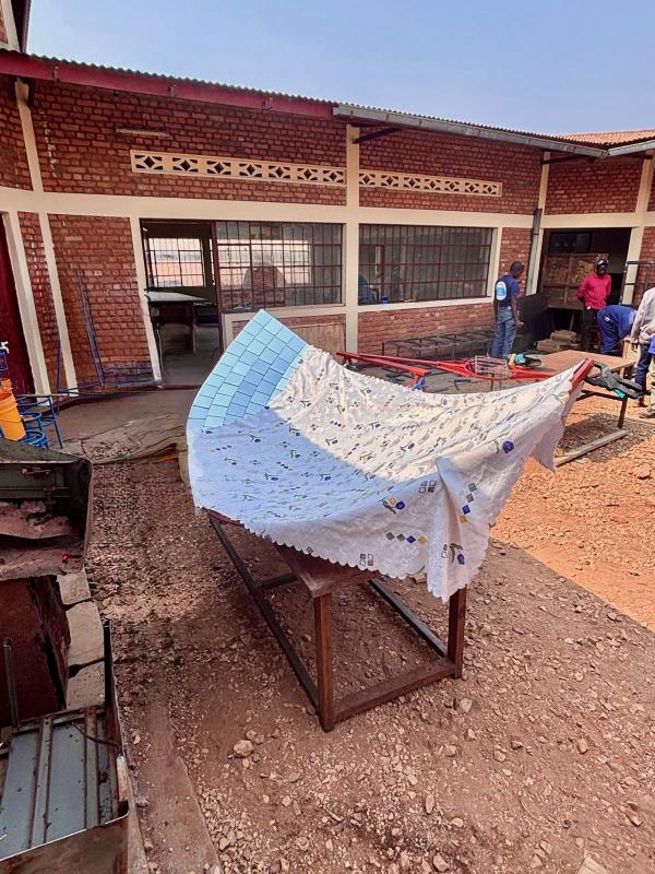 V2SDF training progresses as educators secure the mirror-support panels to the parabolic frame of the SK-23 solar cooker.