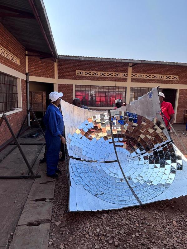 V2SDF training reaches a pivotal phase as educators carefully install the reflective mirrors on the parabolic dish.